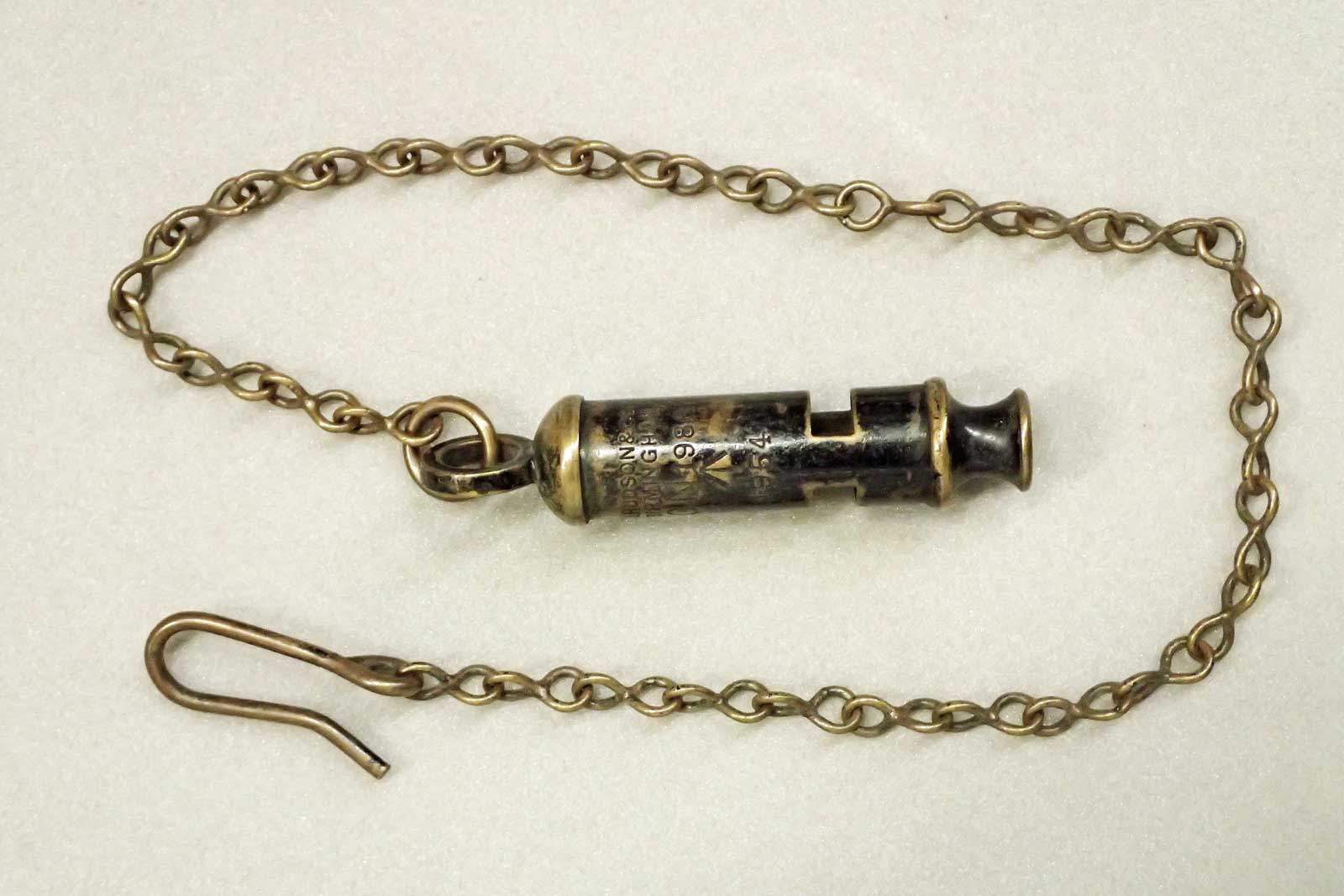 Not all of the whistles in the Postal Museums Collection are stamped G.P.O. or P.O. This possibly reflects where a Postman has supplied his own, or alternative usage. This example also has a length of chain and button hook attached. (2002.477)