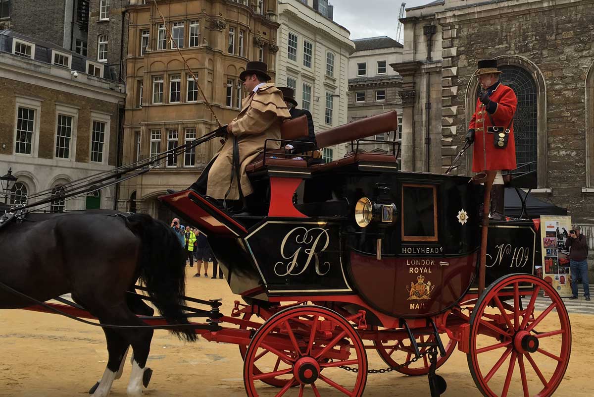 A horse-drawn Mail Coach enters the Guildhall courtyard