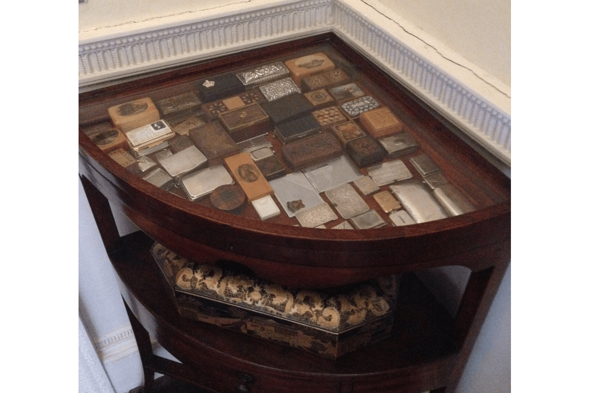 A desk with stamp boxes on show under the glass top