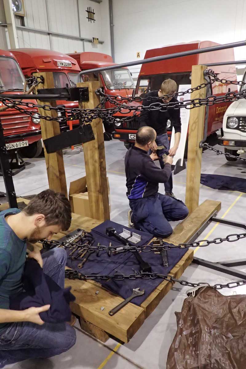 Phil Marshal and Joel Fletcher Hawkins of the Nene Valley Railway laying out the chains during the reconstruction of The Postal Museum's Bag Exchange Apparatus at the Museum Store, Debden