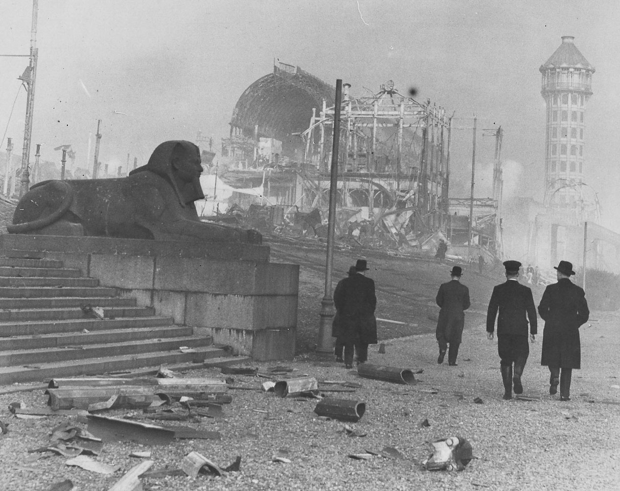 Men walking towards the burnt out Crystal Palace.