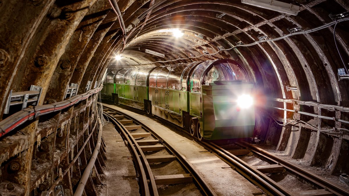 Penny driving a train in Mail Rail tunnels