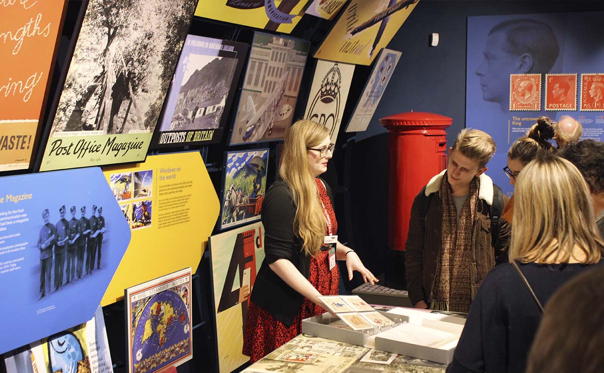 Visitors looking at collection items during a Private tour of the gallery