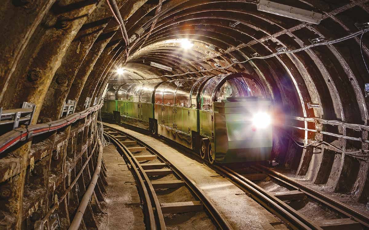 A Mail rail train driving through an underground tunnel