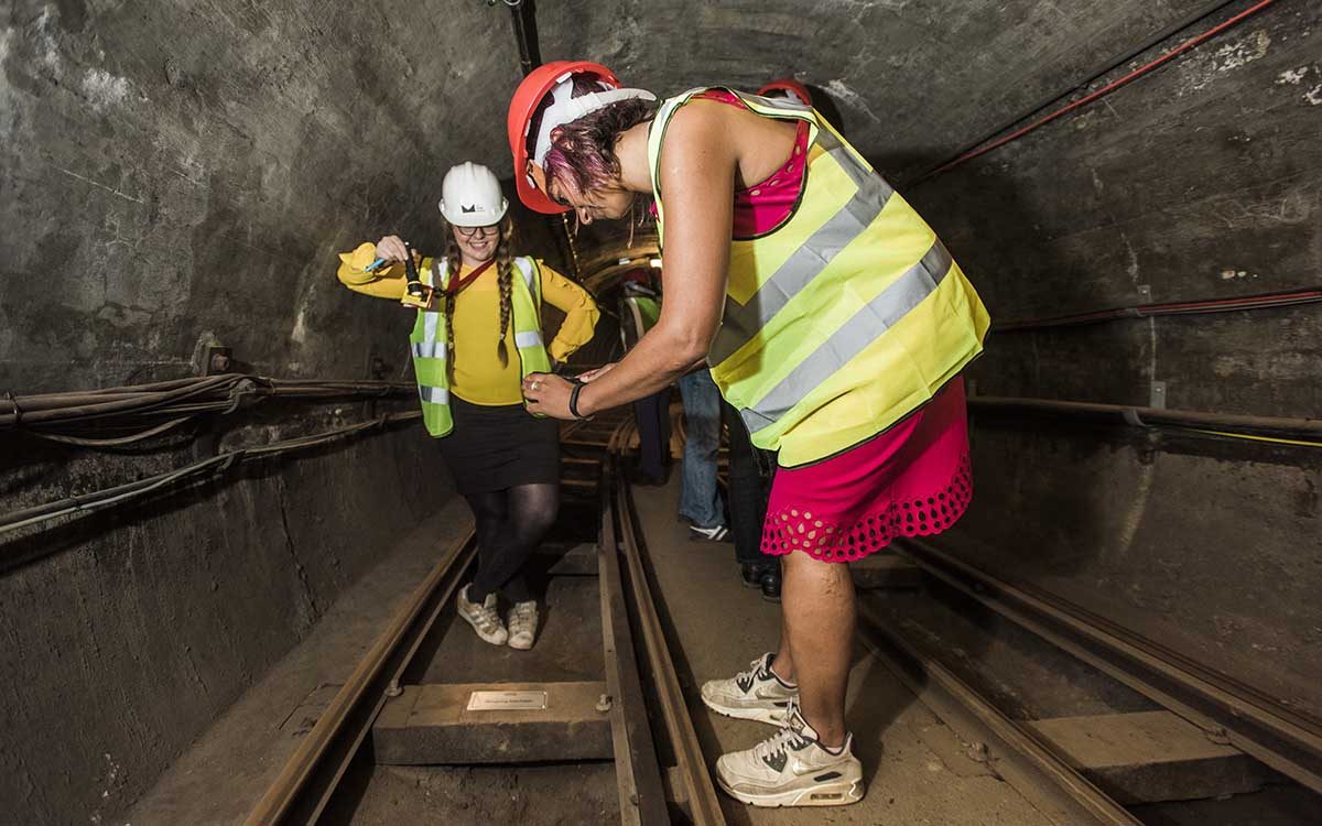 Two sponsors visiting their sleepers during a tour of the underground tunnels of Mail Rail.
