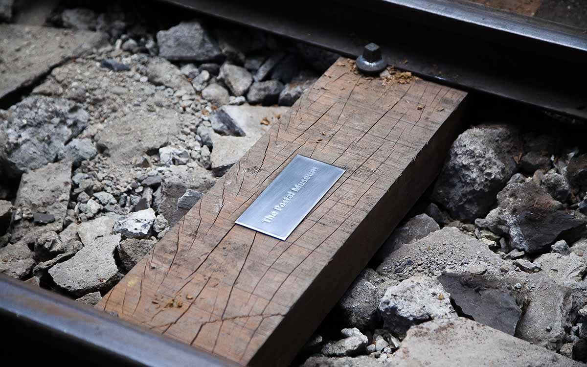 An engraved metal plaque on a wooden sleeper at Mail Rail