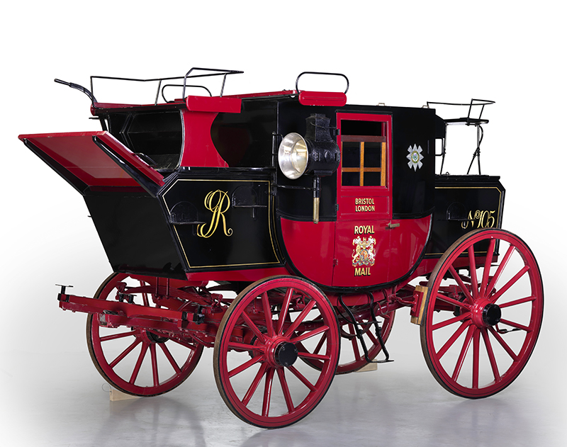 A black and red 18th century mail coach against a white background