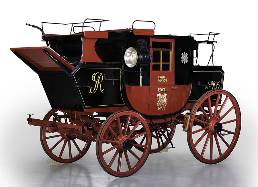 Black and red horse drawn mail coach. Two large wooden wheels at the rear, and two smaller wooden wheels at the front. A window on each side. Beneath the window in gold coloured paint 'BRISTOL/ LONDON'. On the door panel beneath this in multi-coloured paint (predominantly gold coloured) 'ROYAL/ [royal coat of arms]/ MAIL'. Attached beneath the doors on either side are metal fold down steps. To the right of the window is the star of the Order of the Bath composed of rays of silver, charged with an eight pointed Maltese cross. In the centre are three imperial crowns, within a red band marked in gold 'TRIA JUNCTA IN UNO', the motto of the order. The central device is surrounded by two branches of laurel. To the left of the window is the star of the Order of St Patrick, an eight-pointed star at the centre of which is a shamrock bearing three crowns on top of the cross of St Patrick, red on white. This is surrounded by a blue circle bearing, in gold coloured lettering, the motto 'QUIS SEPERABIT MDCCLXXXIII'. On top of the mail coach cab is a bench with two black metal rails either side. In front of this is the driver's position with black cushions and a rail around the edge of the seat with folding back rest, and a sloped wooden foot plate. Below, on the coach body marked in gold coloured paint : 'GR' intertwined. Either side of this are attached metal steps. To the rear of the coach, the body is marked with gold coloured paint: 'No 105'. Above this is a metal stool-like seat with black cushion [cushions are not contemporary]. The interior of the coach is lined with grey material, and black seat cushions. A grey strap is attached to the inside of the window to allow opening/ closing. Horse hitching pole, red with black stripe, and rings and a hook at one end is unattached. This mail coach has been restored from several broken elements found discarded in a farmyard. The body work has been reconstructed on to the original 18th-century undercarriage