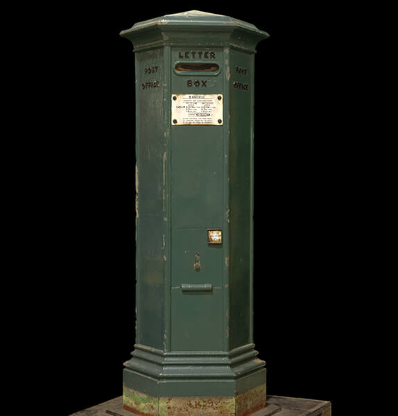 A tall green, siz-sided pillar box, with a horizontal slot near the top. The words 'Letter box' are next to the slot.