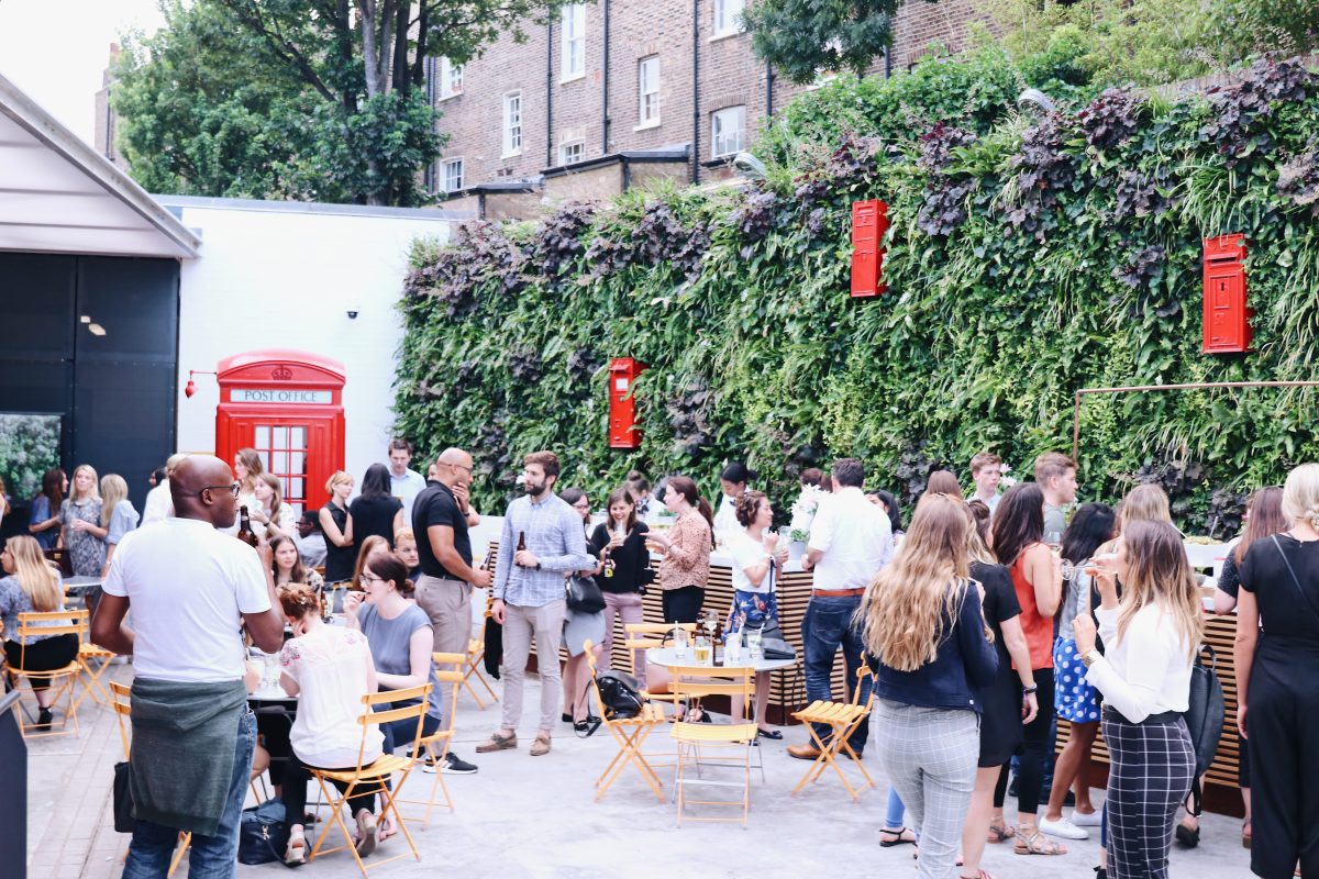 A group of people gather together at The Postal Museum courtyard