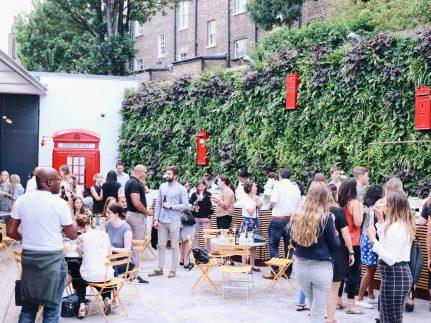 A group of people gather together at The Postal Museum courtyard