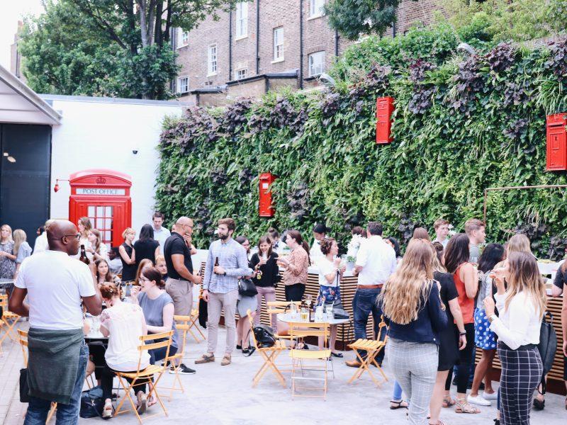 A group of people gather together at The Postal Museum courtyard