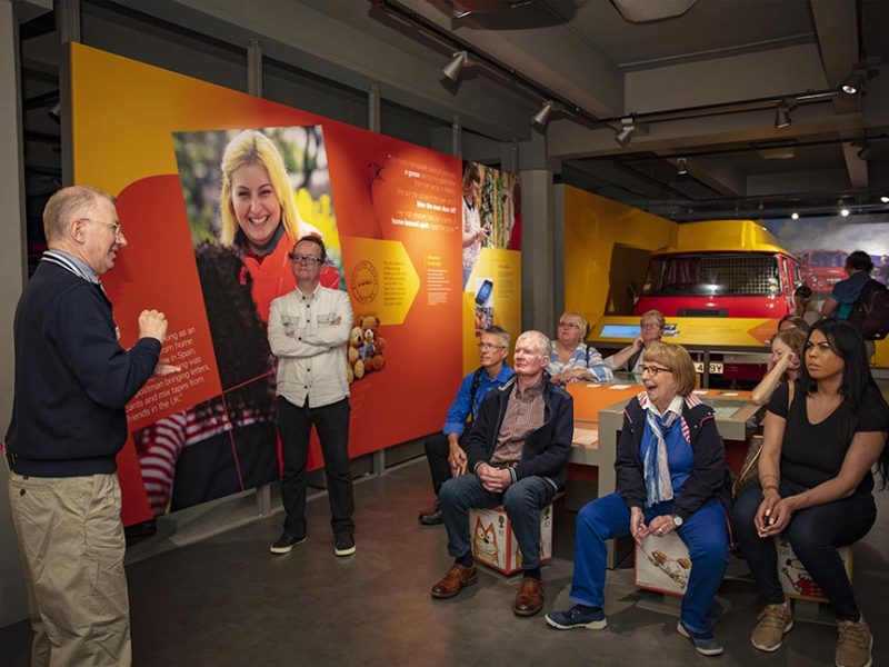 A group of visitors watching a BSL tour guide.