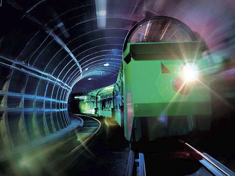 The Mail Rail train drives through a tunnel.