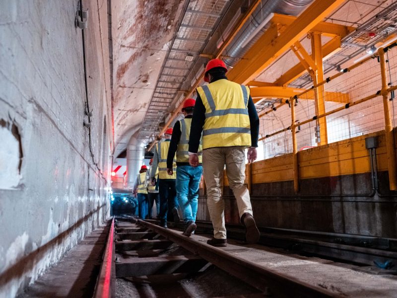 We can see the tour attendees descending down the Mail Rail tunnel, wearing their protective gear.