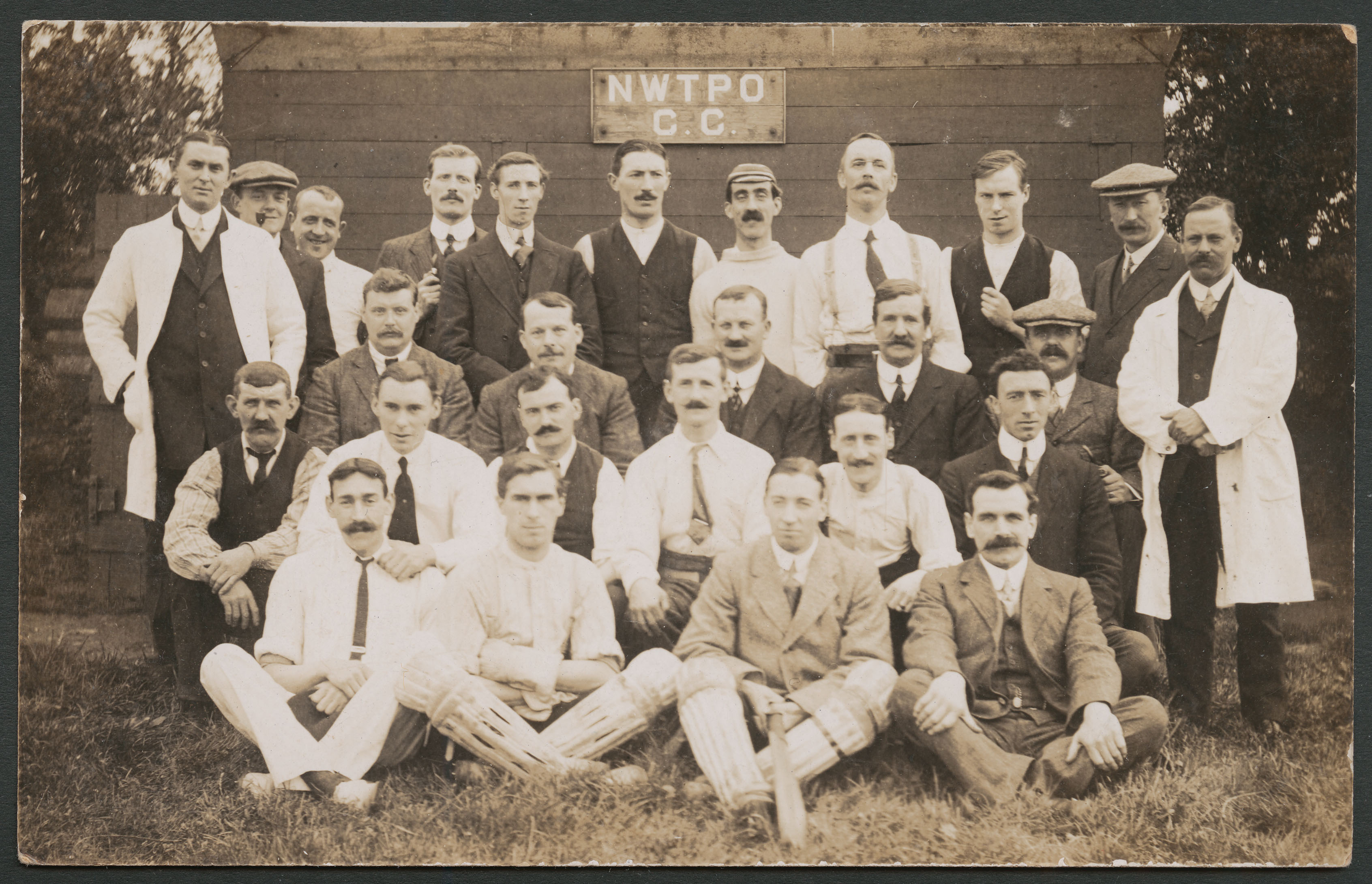 Black and white photograph of a all male Post Office cricket team grouped for a team photograph.