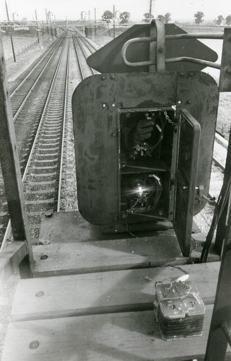 Black and white photograph on the inner workings of a train signal light.