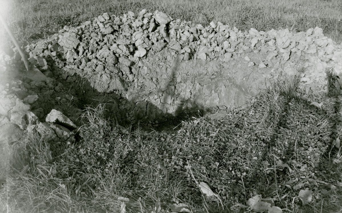 Black and white photograph of the pit dug next to the farm.