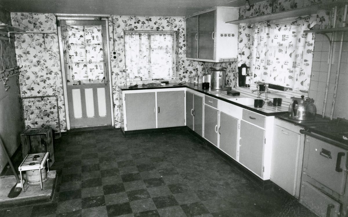 Black and white photograph from inside the farm kitchen.