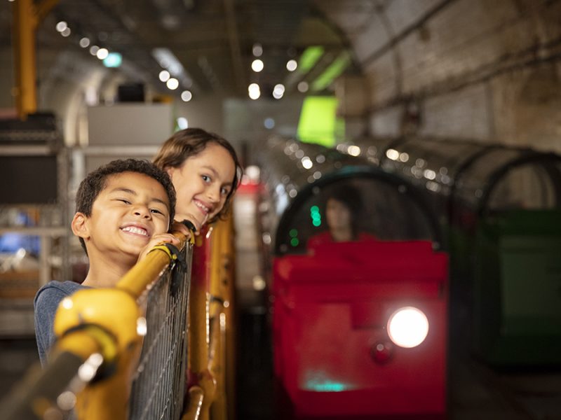 Families waiting in line to ride Mail Rail..