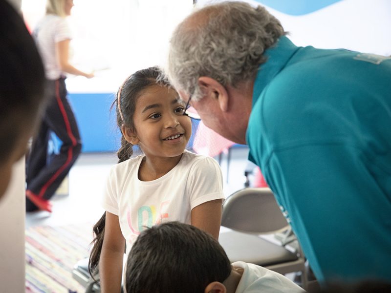 A volunteer and child at a schools session in The Postal Museum.