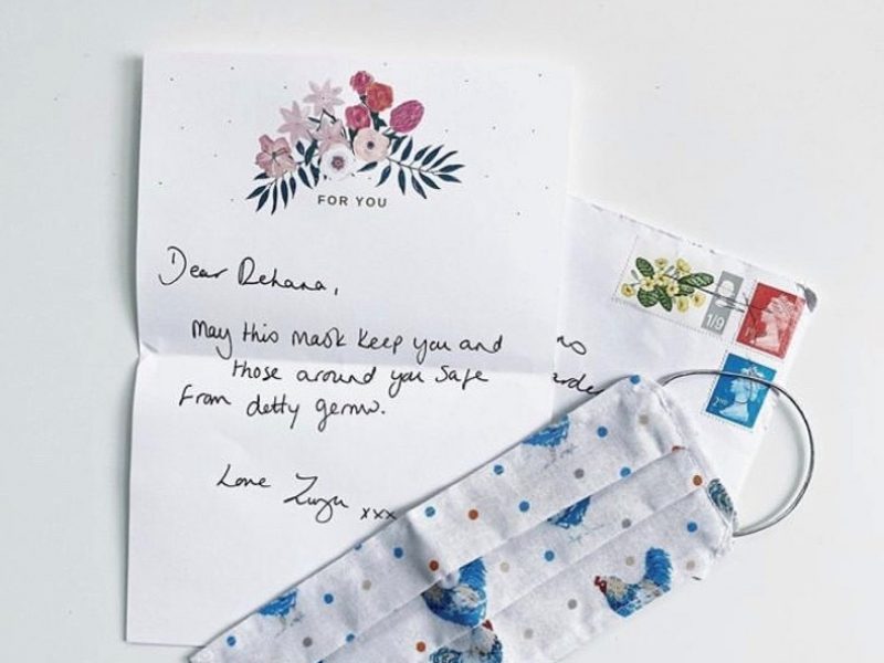 Photo of a handwritten letter and homemade fabric face mask.