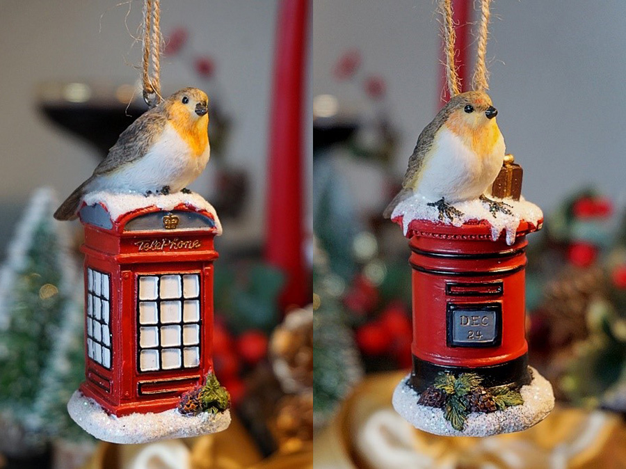 Photo showing two Christmas tree decorations with robins sitting on a letterbox and phonebox.