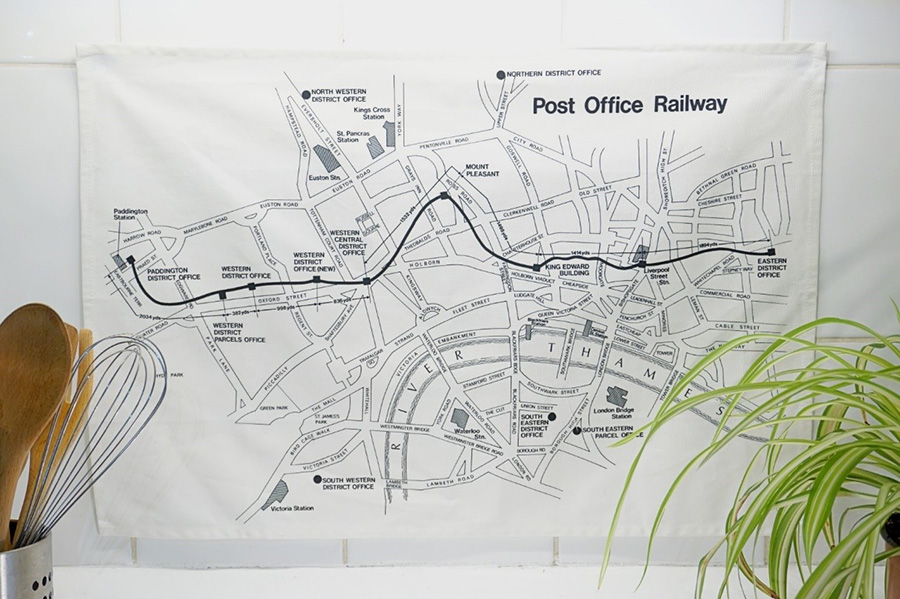 Photo showing a printed tea towel with an old map of the Post Office Railway system.