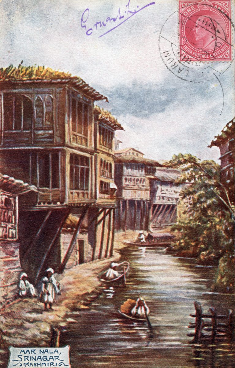 A closeup of a postcard showing a painted scene of people beside a river. The words 'Mar Nala, Srinagar, Kashmir' are in the corner of the card.