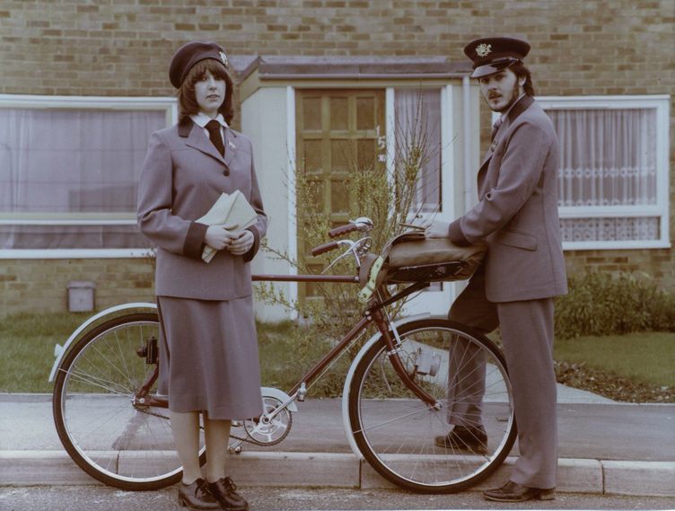 Photo of postal workers in blue summer uniforms.