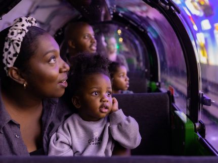 A mother and a child riding Mail Rail. Find your wonder and let's create text included on image.