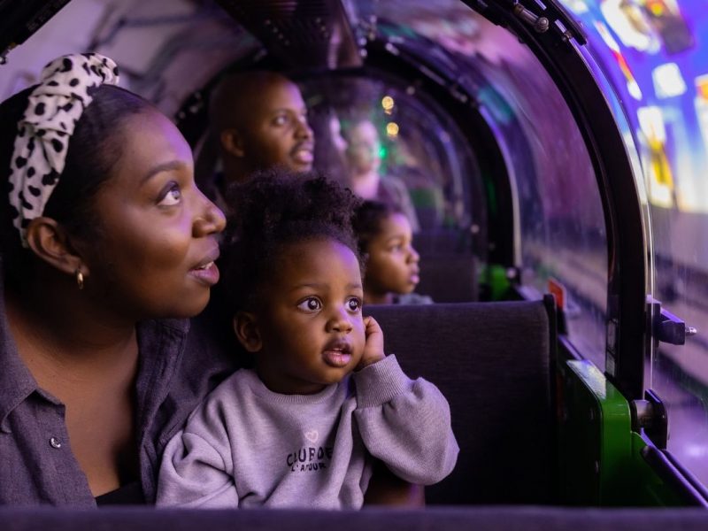 A mother and a child riding Mail Rail. Find your wonder and let's create text included on image.