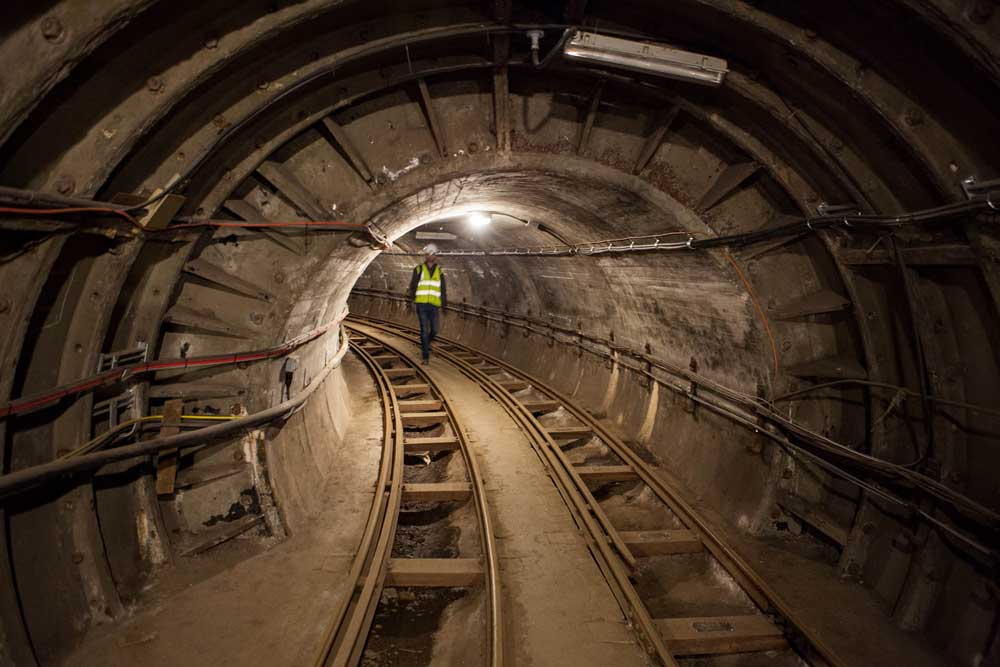 Lone male visitor walking through the tunnel.