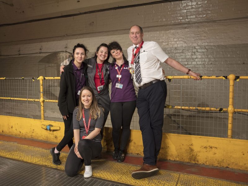 Five members from our Visitor Experience team posing for a photograph
