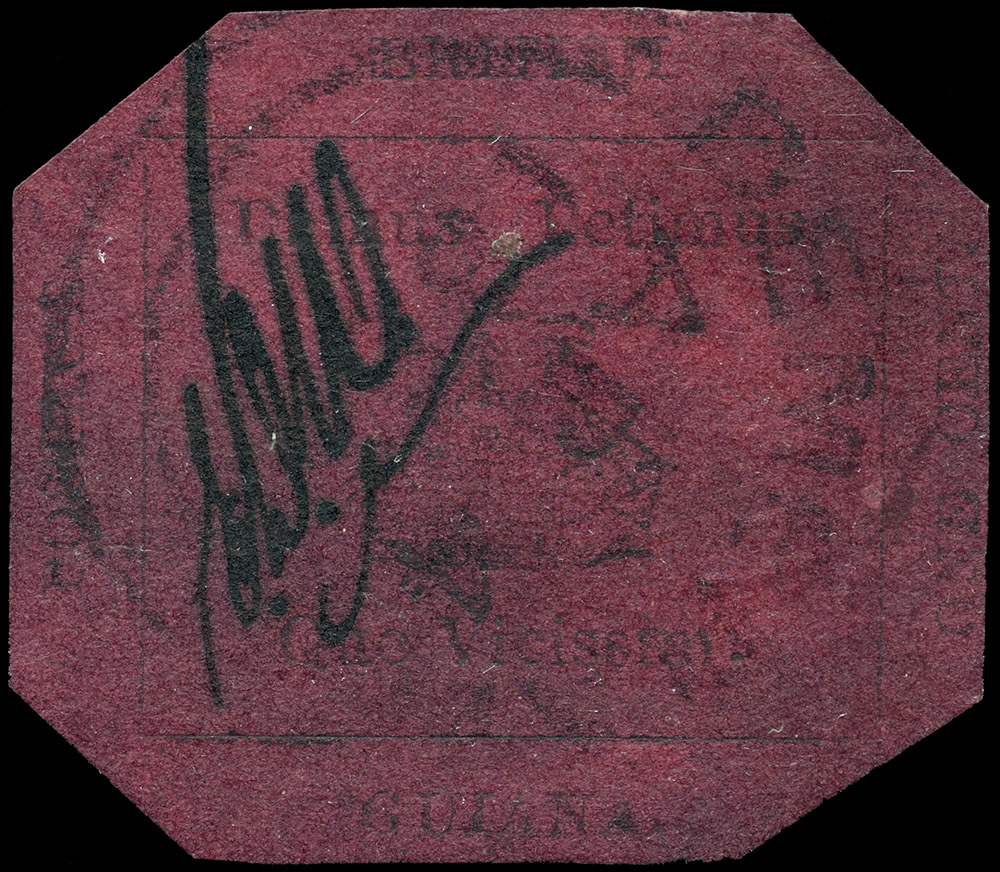 A closeup of a magenta coloured stamp, with very faded, unreadable text printed on the paper in black.