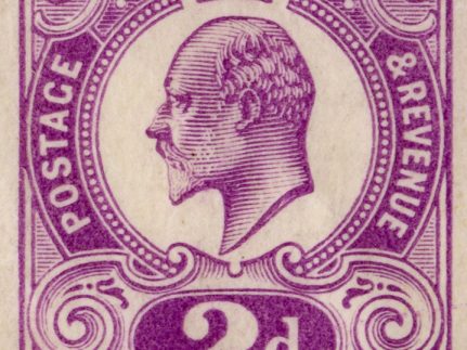 A closeup view of an individual purple stamp, with a portrait of King Edward VII in the middle with a crown, and the words 'Postage & Revenue 2d' around the portrait.