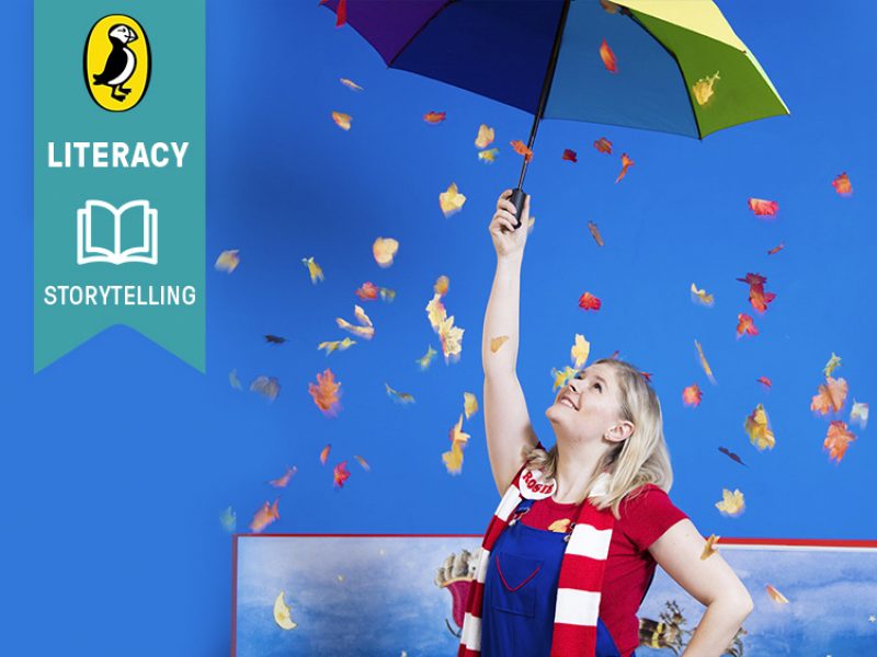 Skills: literacy, storytelling. In the background, Rosie holds a big umbrella and looks up, while leaves fly around.
