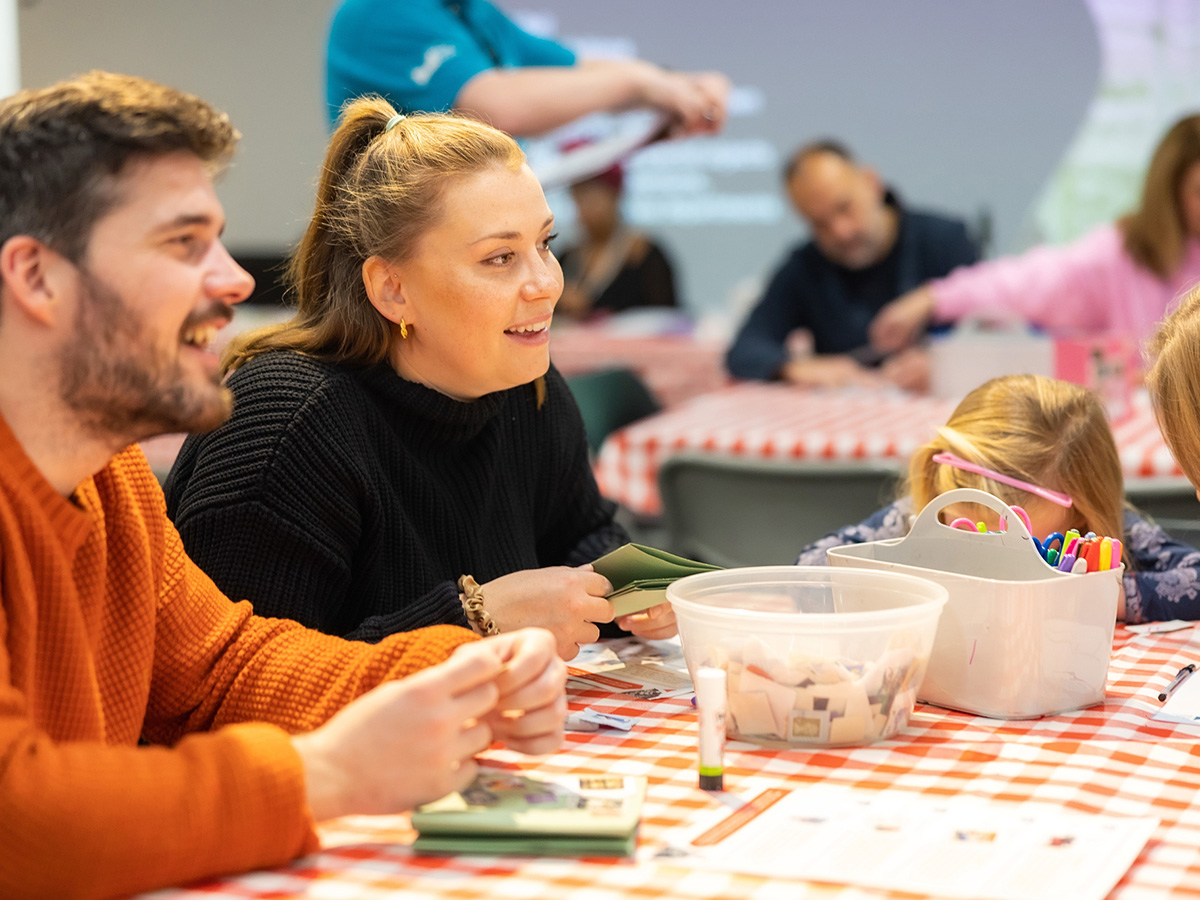 Photo of adults sitting at an arts and crafts table.
