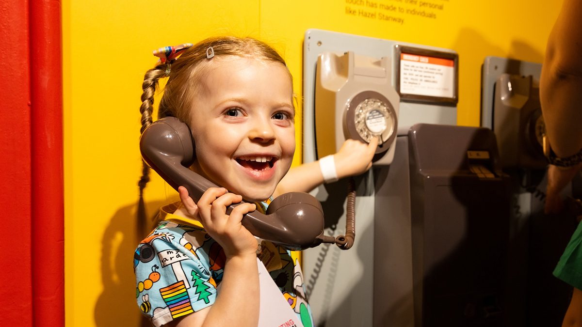 Photo of a girl playing with a telephone in the exhibitions.