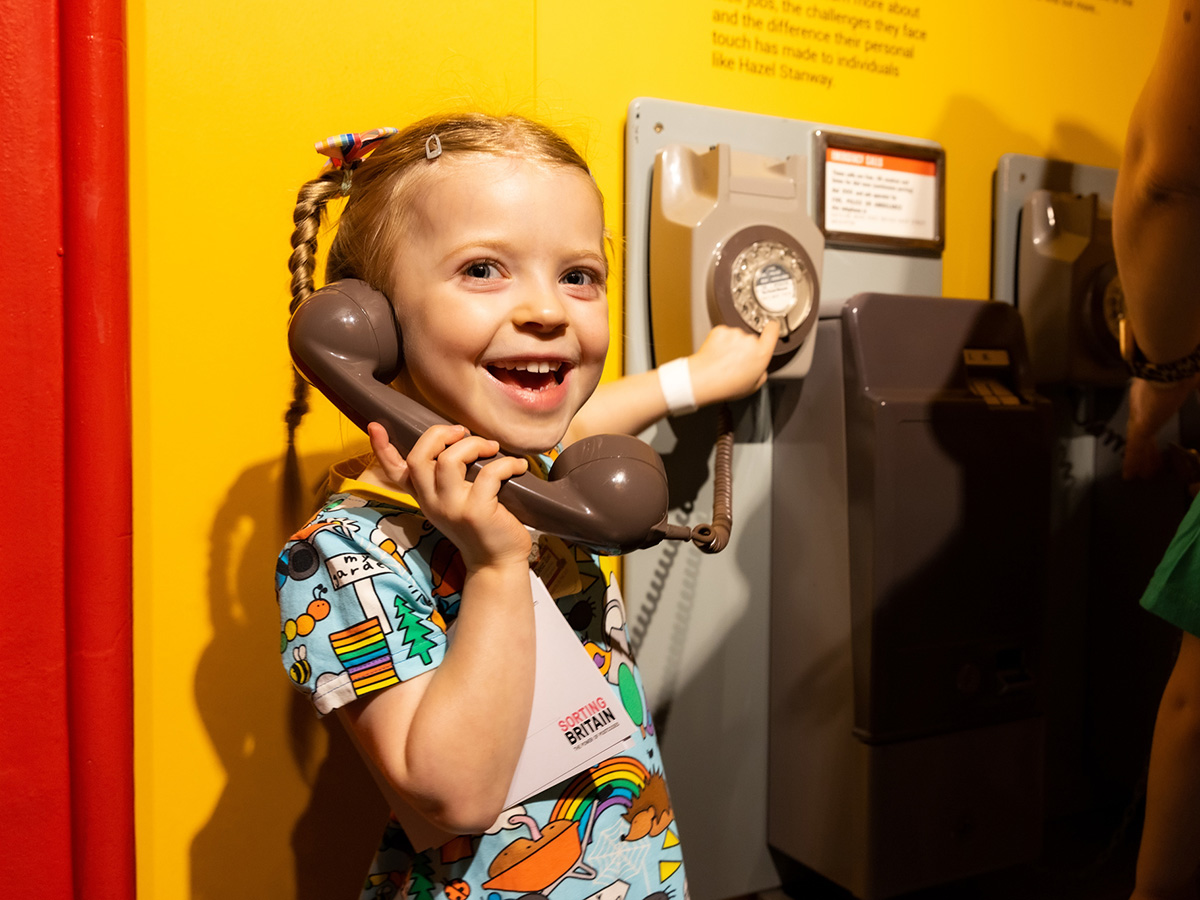 Photo of a girl playing with a telephone in the exhibitions.