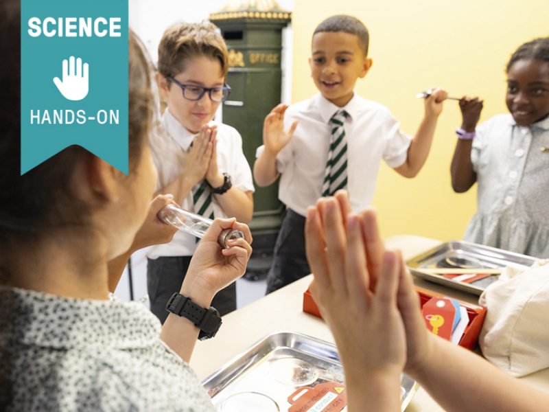 Skills: Science, hands on. A group of school children play a game.