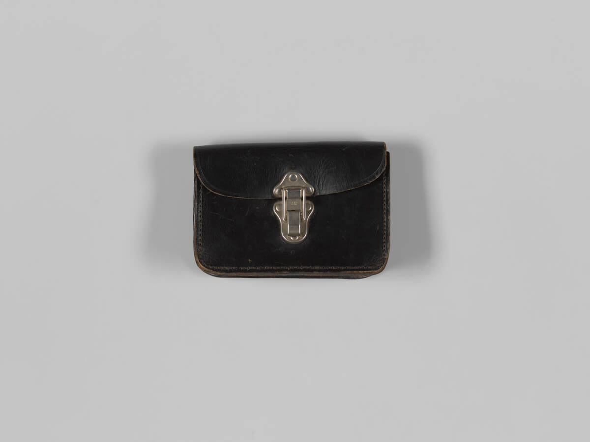 Black leather rectangular pouch about 13cm high, 19cm wide and 4cm deep, with a metal clasp.
