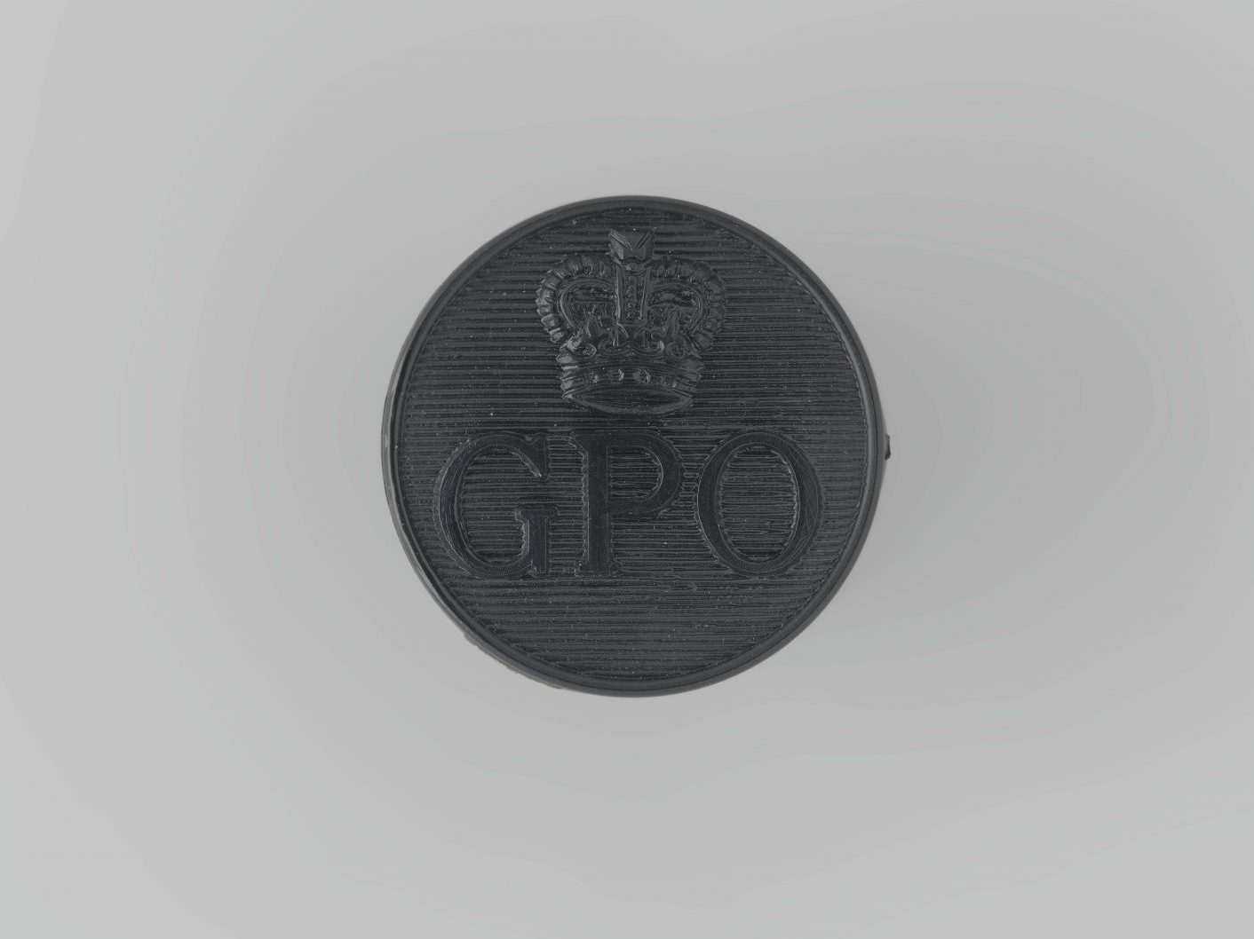 A black bottom with clear letters that read GPO (General Post Office) and the St Edward’s crown