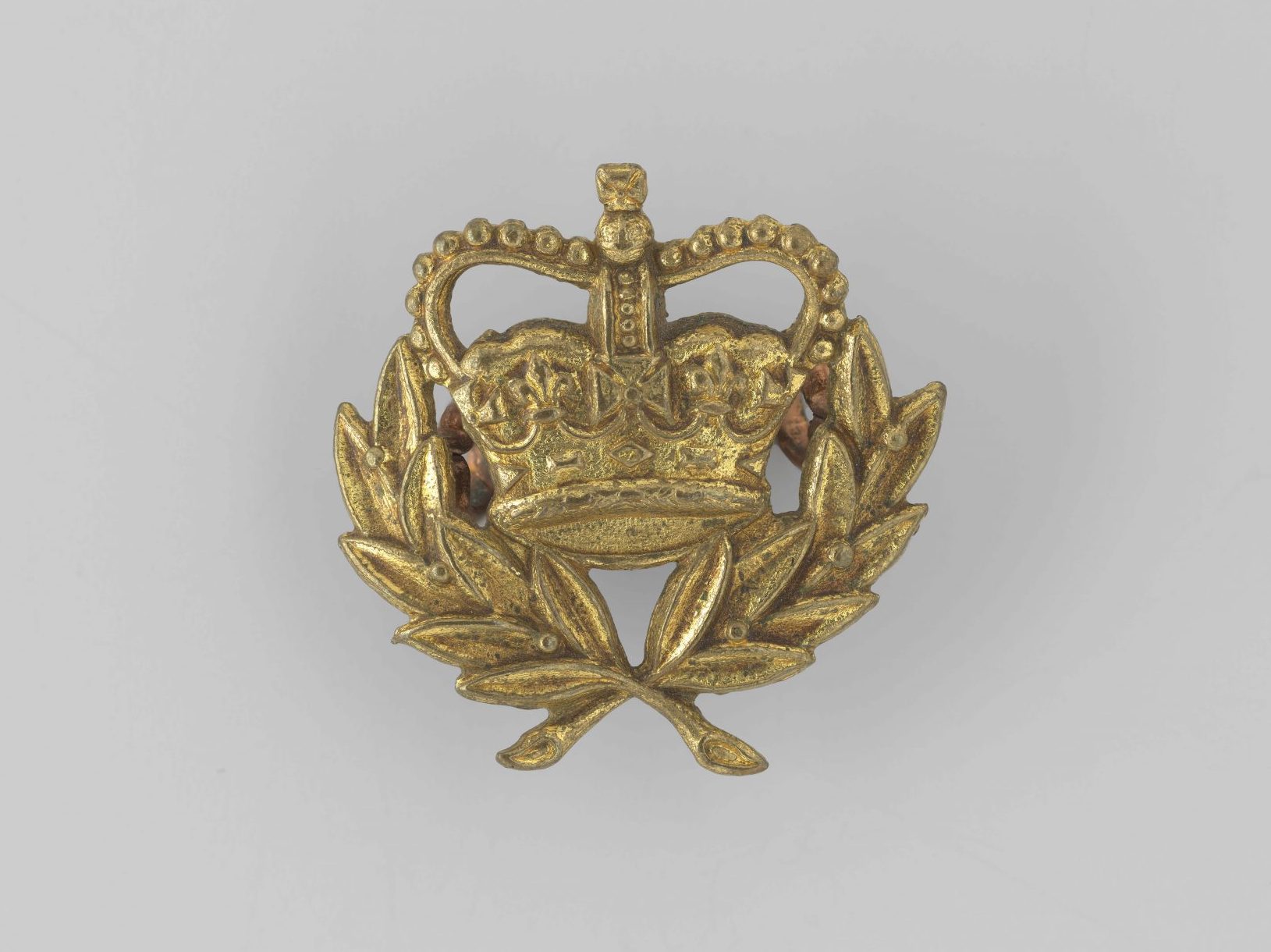 A crown with a top similar to an upside down U. The crown is decorated with fleur de lys, a lily flower with three petals, and a cross at the top and in the middle.