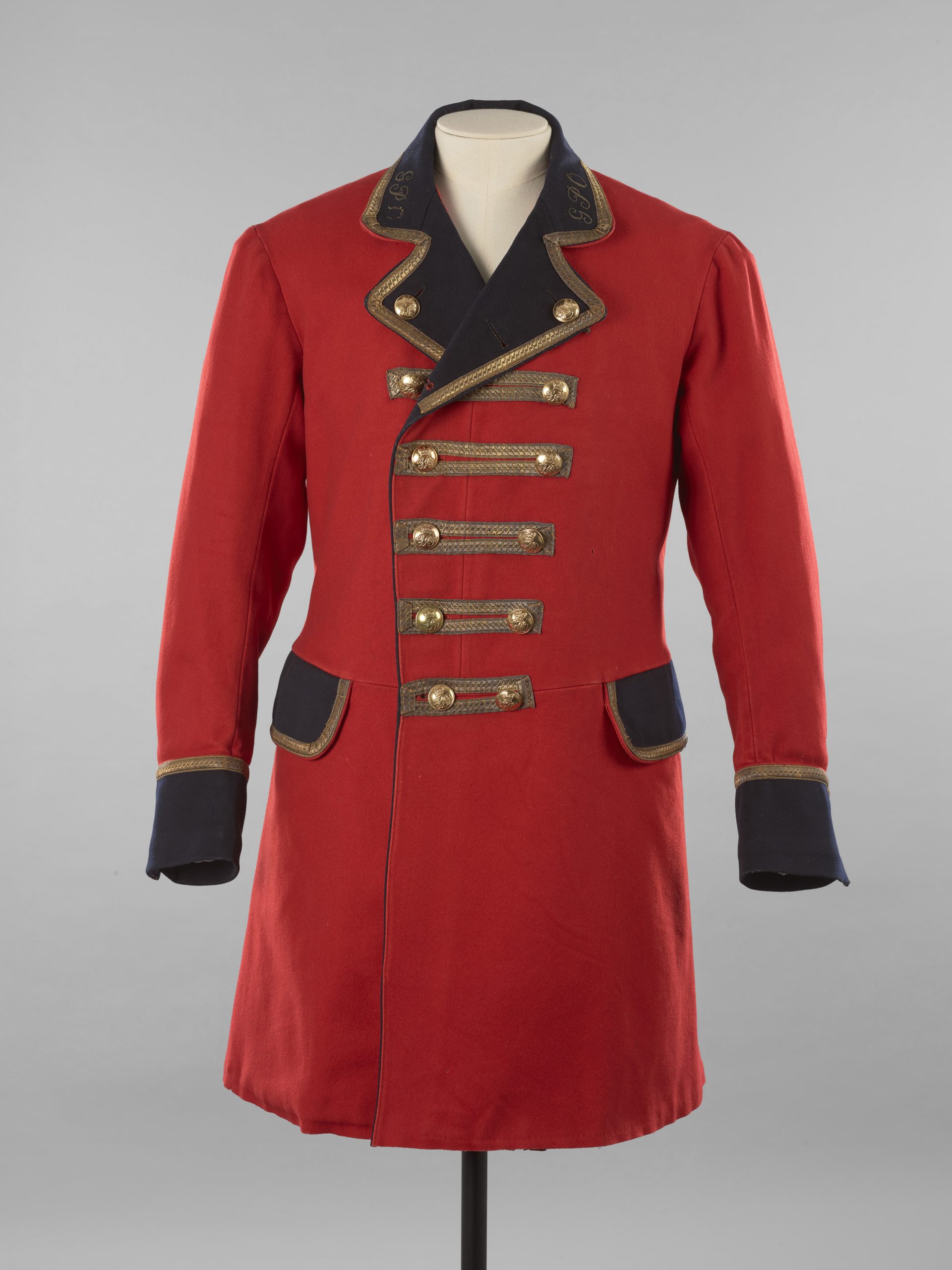 A red frockcoat with black lapel and gold buttons.