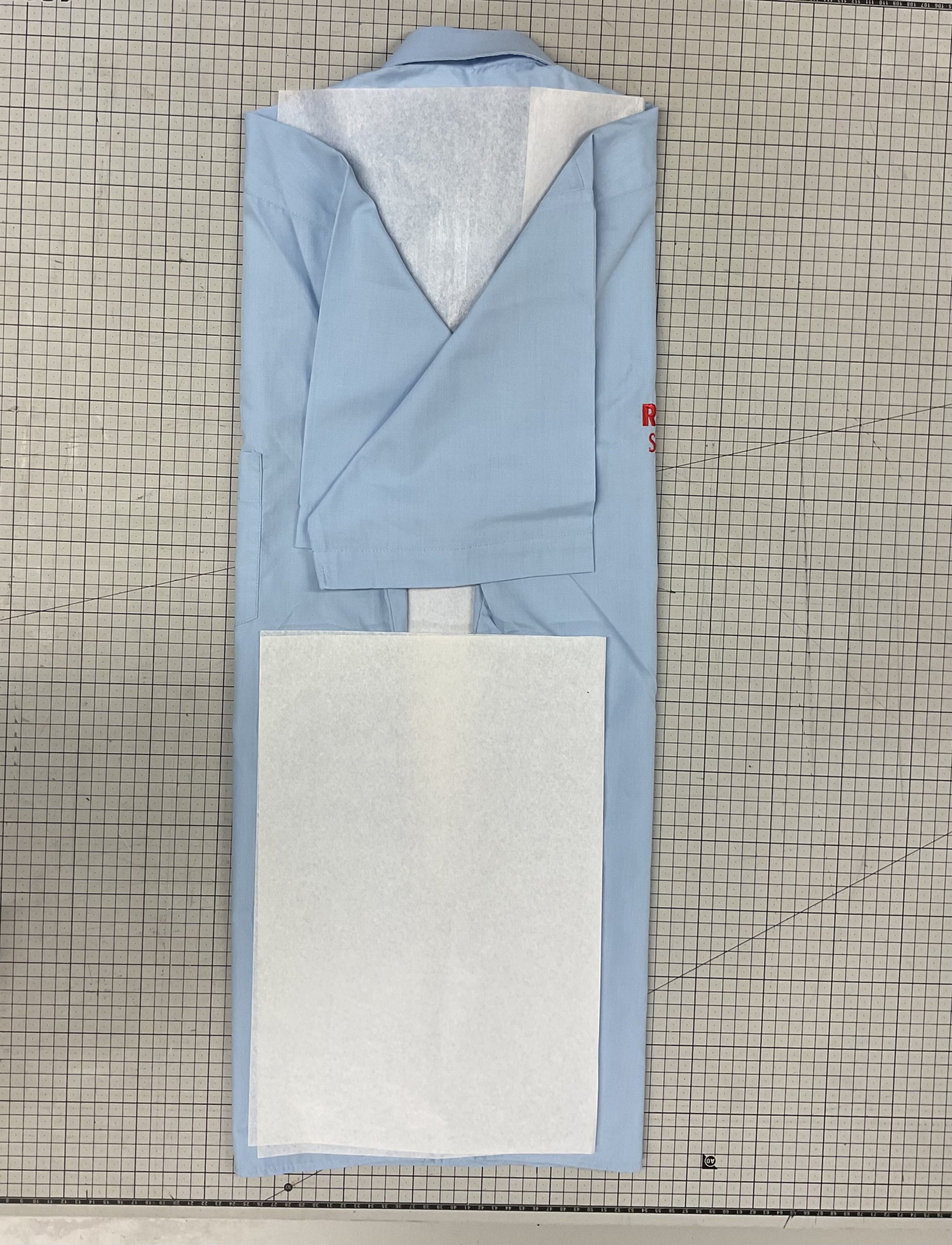 A shirt being fold on a table