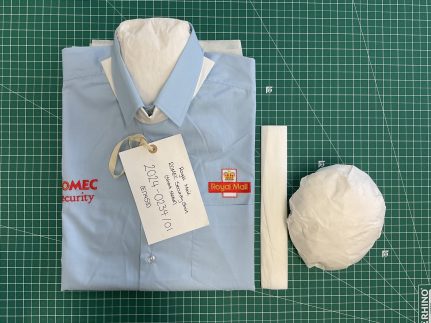 A Royal Mail shirt folded and filled with protective tissue.