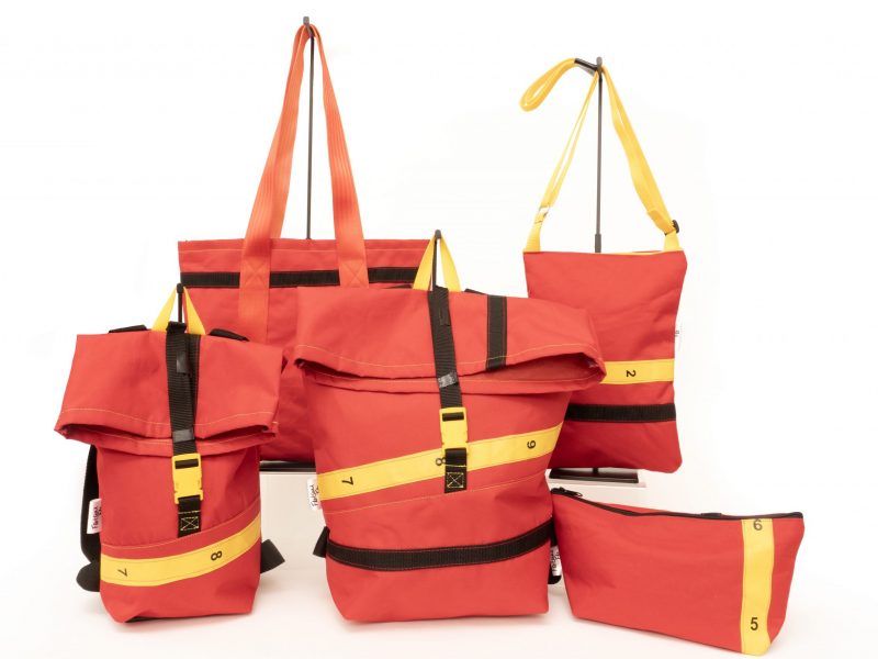 Red bags with black, green and orange straps.