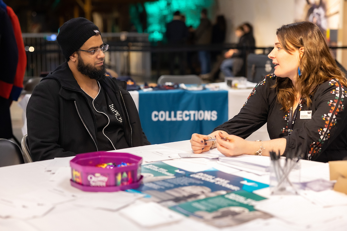 A visitor and a museum facilitator chat