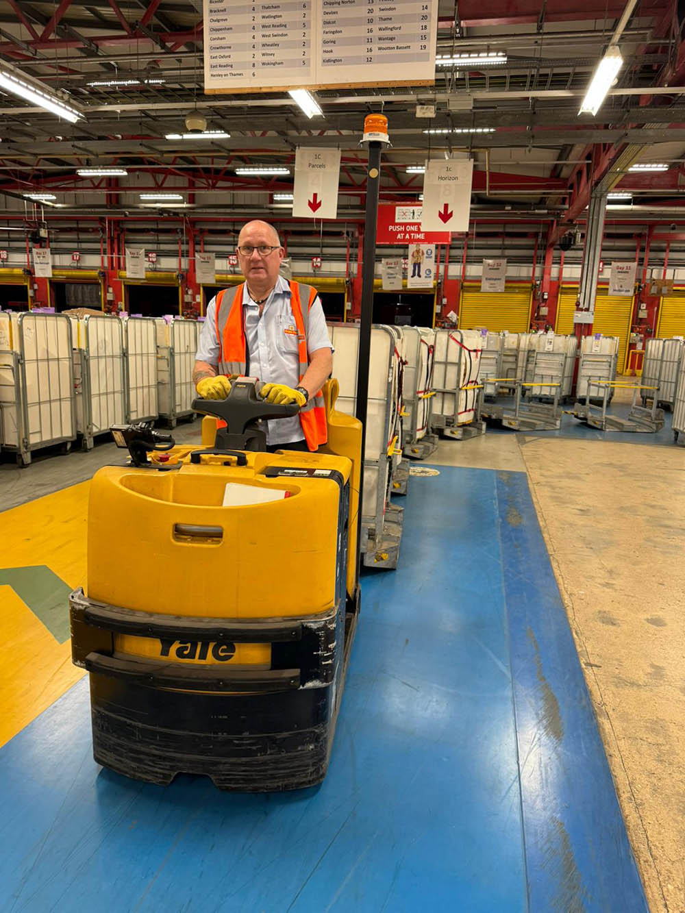 A man driving a yellow machine through the mail centre.